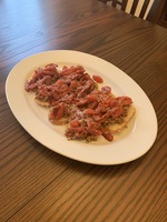 Arranged Bruschetta on a plate placed on wooden table 